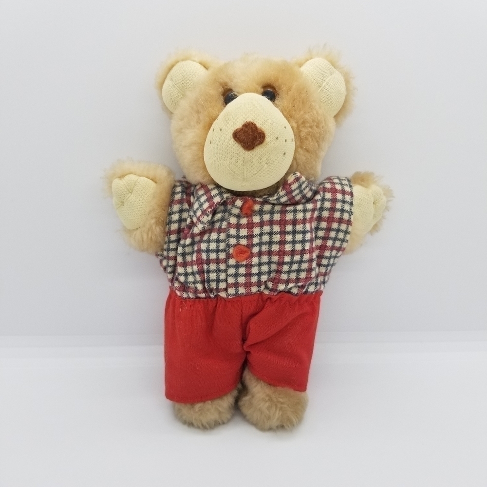 small teddy bear with plaid shirt and red shorts